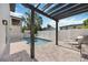 Relaxing poolside with an open pergola, lounge chairs, and privacy fencing at 2590 Floyd St, Sarasota, FL 34239