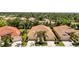 Aerial view of beautiful villas with tile roofs surrounded by lush landscaping at 27243 Ipswich Dr, Englewood, FL 34223