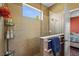 Contemporary bathroom featuring a tiled shower with glass enclosure and integrated shelving for toiletries at 27243 Ipswich Dr, Englewood, FL 34223