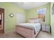 Comfortable bedroom with a wood bed frame, neutral carpet, and a window letting in natural light at 27243 Ipswich Dr, Englewood, FL 34223