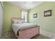 Serene bedroom with soft green walls, carpet floors, and nautical decor accents creating a relaxing retreat at 27243 Ipswich Dr, Englewood, FL 34223