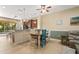 Bright dining area featuring a unique wooden table with colorful chairs and a breakfast bar at 27243 Ipswich Dr, Englewood, FL 34223