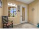 Bright entryway featuring a window, tiled floor, and decorative welcome signs with a chair at 27243 Ipswich Dr, Englewood, FL 34223