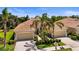 Beautiful villas with a tile roof, two-car garage, and lush landscaping for great curb appeal at 27243 Ipswich Dr, Englewood, FL 34223
