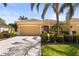 Charming single-story home with a well-manicured lawn, mature landscaping, and a two-car garage at 27243 Ipswich Dr, Englewood, FL 34223