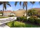 Charming one-story home with a two-car garage, tropical landscaping, and a well-maintained lawn at 27243 Ipswich Dr, Englewood, FL 34223