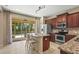 Bright kitchen featuring stainless steel appliances, a central island, and a sliding glass door to the lanai at 27243 Ipswich Dr, Englewood, FL 34223