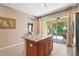 Bright kitchen featuring a central island, granite countertops and a sliding glass door to the outdoor at 27243 Ipswich Dr, Englewood, FL 34223