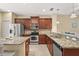 Modern kitchen with stainless steel appliances, granite countertops, and wood cabinets offers style and convenience at 27243 Ipswich Dr, Englewood, FL 34223