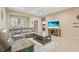 Comfortable living room with a large leather sectional, ceiling fan, and stylishly decorated table at 27243 Ipswich Dr, Englewood, FL 34223