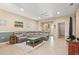 Inviting living area with a large sectional sofa, ceiling fan, decorative tables and tile flooring at 27243 Ipswich Dr, Englewood, FL 34223