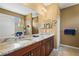 Well-appointed bathroom with double sinks, granite countertops, and a tiled shower, creating a spa-like experience at 27243 Ipswich Dr, Englewood, FL 34223