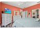 Inviting bedroom with calming decor, a ceiling fan, and a view into the ensuite bathroom and kitchen at 27243 Ipswich Dr, Englewood, FL 34223