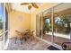 Enclosed patio with stone flooring, wicker furniture, and sliding glass doors to view the yard at 27243 Ipswich Dr, Englewood, FL 34223