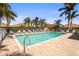Sparkling community pool surrounded by palm trees and lounge chairs, perfect for a refreshing swim at 27243 Ipswich Dr, Englewood, FL 34223