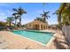 Community pool featuring palm trees, lounge chairs, a pool house and cool water for warm days at 27243 Ipswich Dr, Englewood, FL 34223