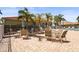 Community patio with tables and chairs next to the pool to relax at at 27243 Ipswich Dr, Englewood, FL 34223