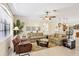 Inviting living room with tile flooring, ceiling fan, and comfortable plaid sofas for relaxing at 2871 Phoenix Palm Ter, North Port, FL 34288
