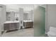 Sleek bathroom features dual vanities, a glass-enclosed shower, and modern fixtures at 300 S Pineapple Ave # 302, Sarasota, FL 34236