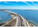 Aerial view of a scenic bridge stretching over the water, lined with palm trees and clear blue water at 300 S Pineapple Ave # 302, Sarasota, FL 34236