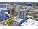 Striking view of the high-rise with a pool, surrounded by buildings, and landscaping at 300 S Pineapple Ave # 302, Sarasota, FL 34236