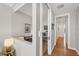 Hallway leading to office area with modern shelving and wood flooring throughout at 300 S Pineapple Ave # 302, Sarasota, FL 34236