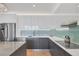 Open kitchen with stainless steel appliances, a large island, and modern finishes at 300 S Pineapple Ave # 302, Sarasota, FL 34236