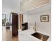 Kitchen bar featuring a sink, cabinet and hardwood flooring at 300 S Pineapple Ave # 302, Sarasota, FL 34236