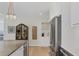 Kitchen area with stainless refrigerator, bar area with sink, and hardwood flooring at 300 S Pineapple Ave # 302, Sarasota, FL 34236