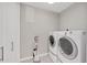 Practical laundry room with washer, dryer, and plenty of storage space at 300 S Pineapple Ave # 302, Sarasota, FL 34236