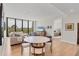 Spacious living room showcasing hardwood floors and a beautiful view from the expansive windows at 300 S Pineapple Ave # 302, Sarasota, FL 34236