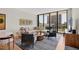 Modern living room with an open balcony and comfortable seating on a textured rug at 300 S Pineapple Ave # 302, Sarasota, FL 34236