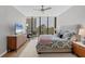 Bright bedroom with floor to ceiling windows and a TV at 300 S Pineapple Ave # 302, Sarasota, FL 34236