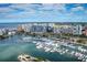 Stunning aerial view of the marina, docks, and city skyline along a beautiful waterfront at 300 S Pineapple Ave # 302, Sarasota, FL 34236