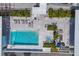 Aerial view of a luxury pool with lounge seating and meticulous landscaping at 300 S Pineapple Ave # 302, Sarasota, FL 34236