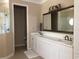 Bright bathroom boasts a double vanity with white cabinets and a separate glass-enclosed shower at 3405 54Th W Dr # 104, Bradenton, FL 34210
