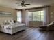 Sun-drenched primary bedroom featuring a large window and comfortable chaise lounge at 3405 54Th W Dr # 104, Bradenton, FL 34210