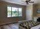 Spacious bedroom with large window, ceiling fan, and closet at 3405 54Th W Dr # 104, Bradenton, FL 34210