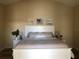 Calm bedroom with white headboard, bedside tables, lamps and beach-themed artwork at 3405 54Th W Dr # 104, Bradenton, FL 34210