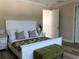 Comfortable bedroom with a white bed frame, bench and neutral decor at 3405 54Th W Dr # 104, Bradenton, FL 34210