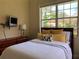 Bright bedroom featuring a large window and comfortable furnishings at 3405 54Th W Dr # 104, Bradenton, FL 34210