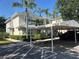 Inviting exterior showcases a tropical landscaped yard, carport, and soft yellow siding at 3405 54Th W Dr # 104, Bradenton, FL 34210