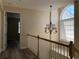Hallway with chandelier and arch window with natural light at 3405 54Th W Dr # 104, Bradenton, FL 34210