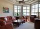 Cozy living room boasts an abundance of natural light and a tray ceiling with a ceiling fan at 3405 54Th W Dr # 104, Bradenton, FL 34210