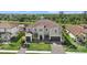 Aerial view of an elegant two-story home with a three-car garage and well-manicured lawn at 3415 Big Sky Way, Bradenton, FL 34211