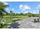 The backyard has a serene pond view with a paver patio and lush landscaping at 3415 Big Sky Way, Bradenton, FL 34211
