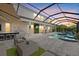 Spacious backyard area with a pool, outdoor kitchen, and comfortable seating under a screened enclosure at 3415 Big Sky Way, Bradenton, FL 34211
