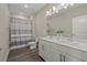 Bathroom with a double sink vanity, modern fixtures, and a shower with a stylish curtain at 3415 Big Sky Way, Bradenton, FL 34211