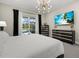 Bright bedroom featuring black and gold furnishings, modern lighting and an outdoor view at 3415 Big Sky Way, Bradenton, FL 34211