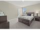 Well-lit bedroom featuring a wooden bed, neutral walls, and dark furniture offering a relaxing atmosphere at 3415 Big Sky Way, Bradenton, FL 34211